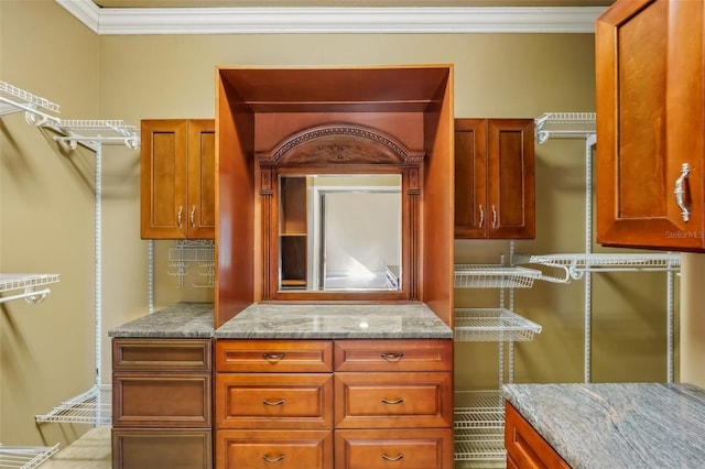 kitchen with light stone countertops and ornamental molding