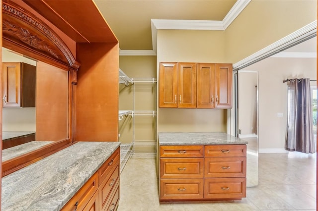 kitchen with light stone counters and crown molding