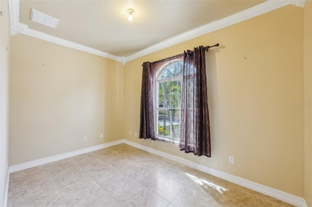 spare room with crown molding