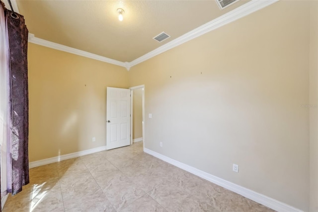 spare room featuring crown molding