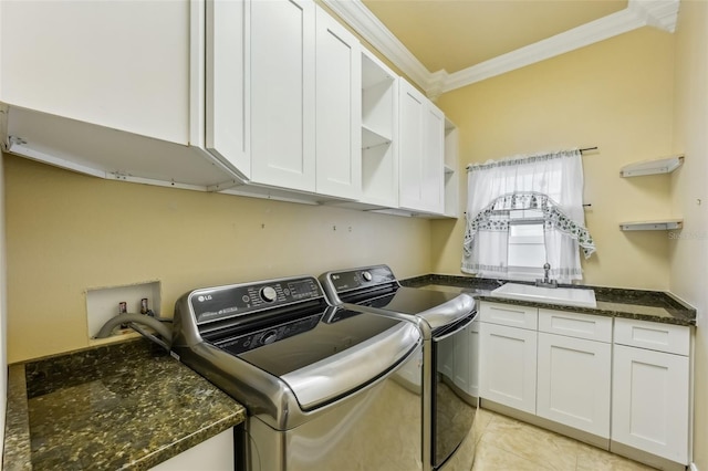 laundry room featuring cabinets, crown molding, sink, washing machine and dryer, and light tile patterned flooring