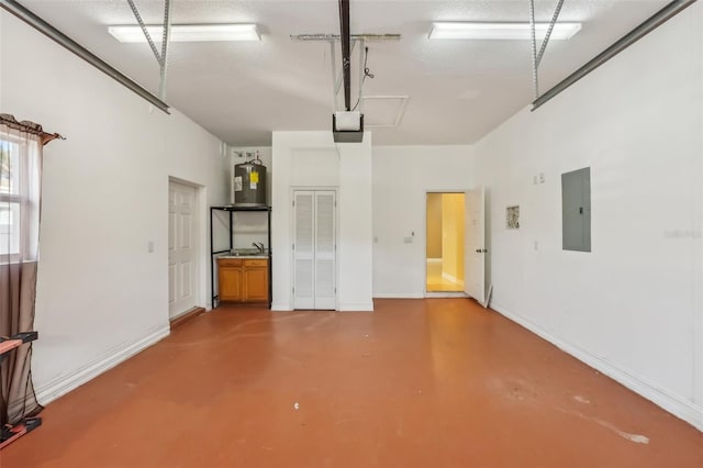 garage featuring a garage door opener, sink, electric panel, and water heater