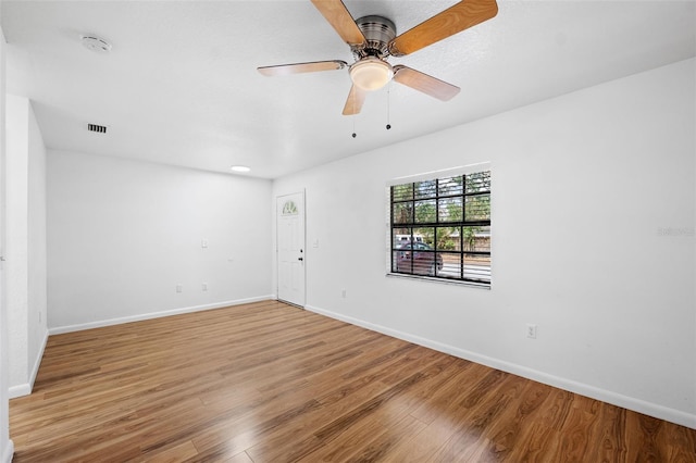 unfurnished room with hardwood / wood-style floors and ceiling fan