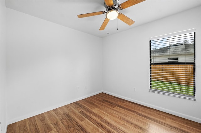 empty room with ceiling fan and hardwood / wood-style flooring