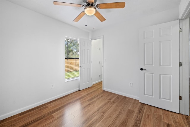 unfurnished room with ceiling fan and light wood-type flooring