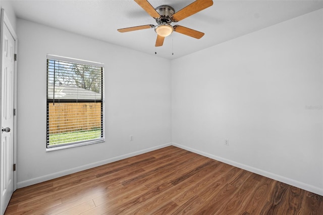 unfurnished room featuring hardwood / wood-style floors, ceiling fan, and a healthy amount of sunlight