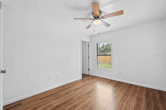 spare room featuring ceiling fan and hardwood / wood-style floors