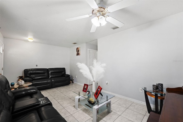 tiled living room with ceiling fan