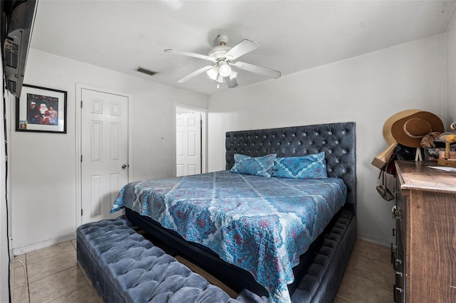 bedroom with ceiling fan and light tile patterned floors