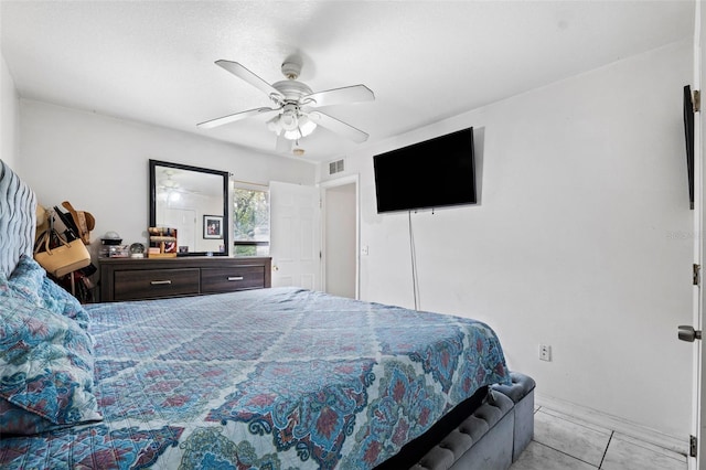 tiled bedroom featuring ceiling fan