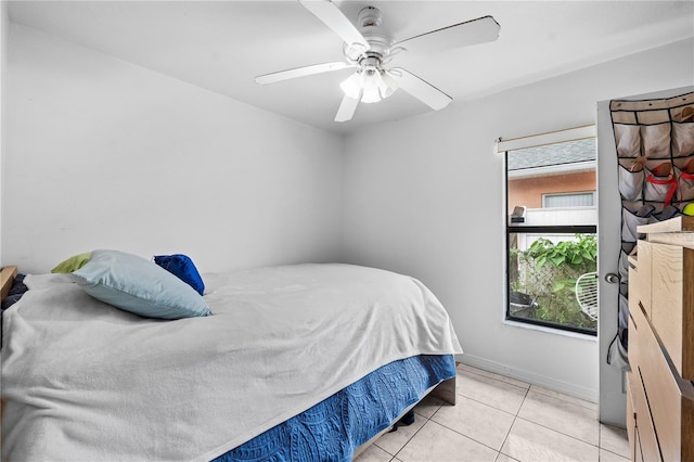 bedroom with ceiling fan and light tile patterned flooring