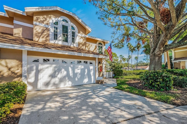 view of front facade with a garage and central AC