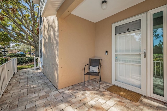 view of exterior entry with a patio