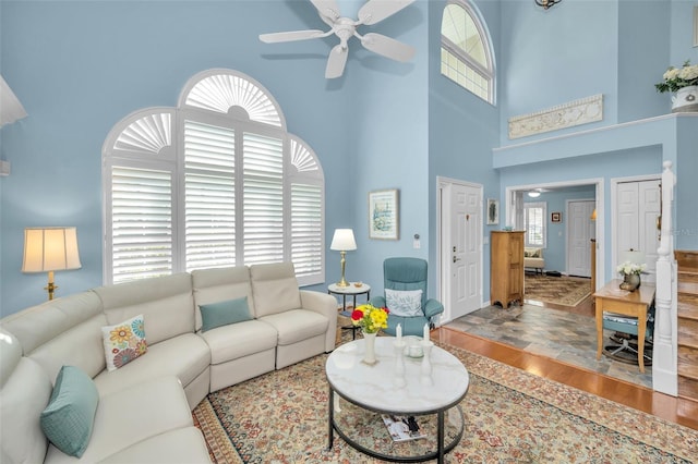 living room featuring plenty of natural light and a towering ceiling