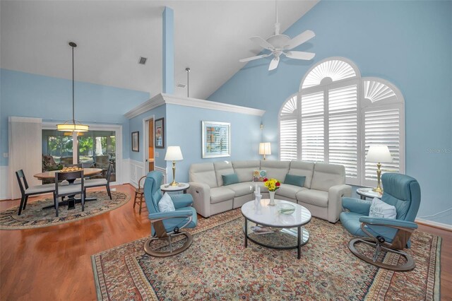 living room with wood-type flooring, high vaulted ceiling, and ceiling fan