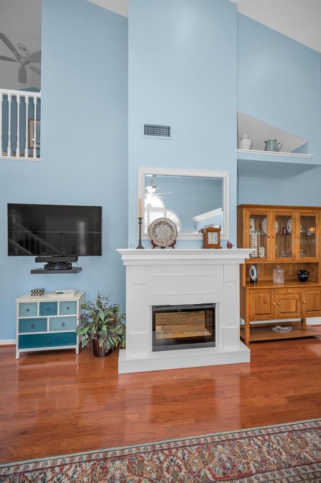 living room featuring hardwood / wood-style floors and high vaulted ceiling