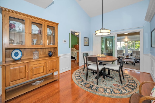 dining area featuring lofted ceiling and light hardwood / wood-style flooring