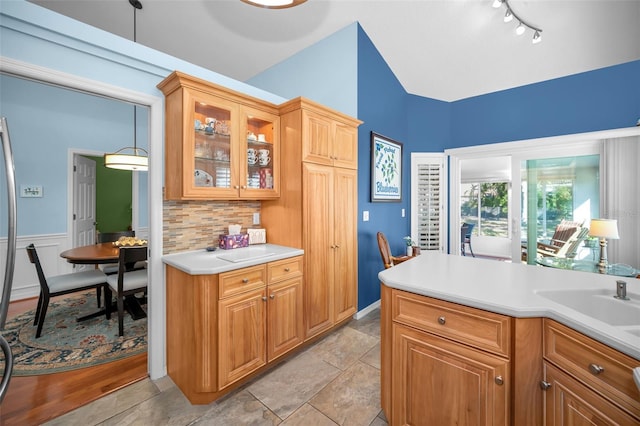 kitchen featuring tasteful backsplash, hanging light fixtures, and light tile patterned flooring