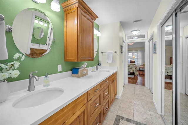 bathroom featuring tile patterned flooring and vanity