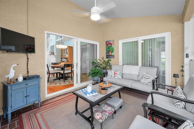 living room with ceiling fan and vaulted ceiling