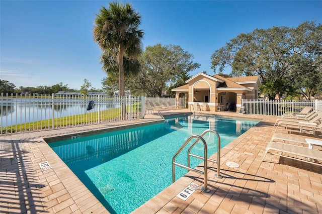 view of pool featuring a patio area and a water view