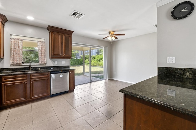 kitchen with dark stone counters, ceiling fan, sink, dishwasher, and light tile patterned flooring