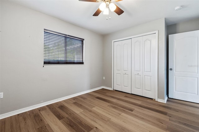 unfurnished bedroom featuring a closet, ceiling fan, and hardwood / wood-style floors