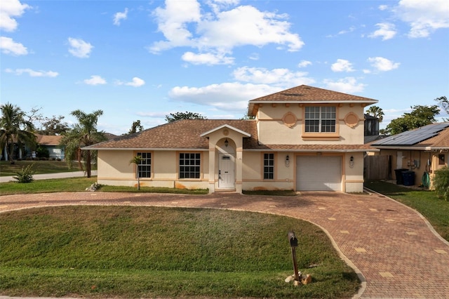 mediterranean / spanish-style home featuring a front yard and a garage