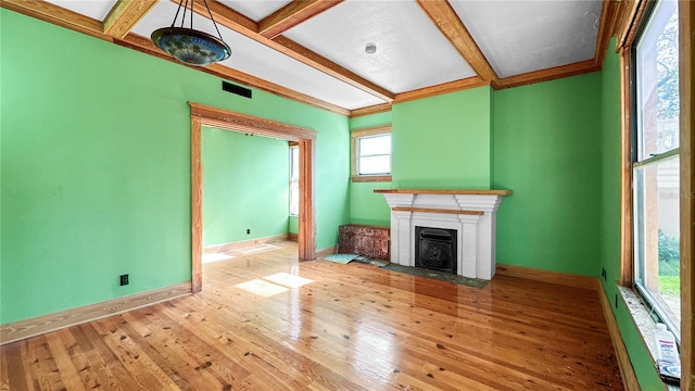 unfurnished living room featuring beam ceiling, light wood-type flooring, and coffered ceiling