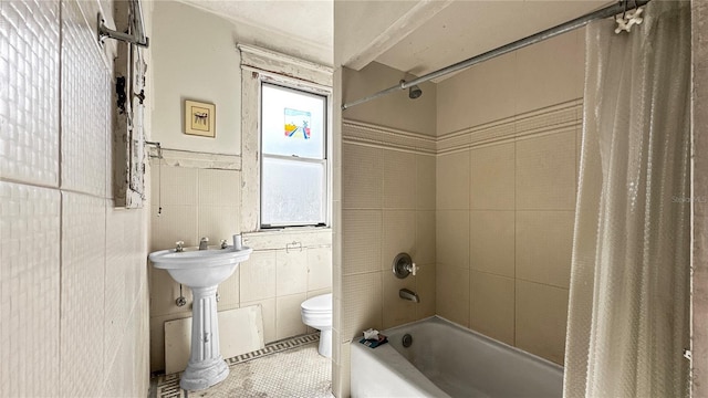 bathroom featuring shower / bath combination with curtain, tile walls, and toilet