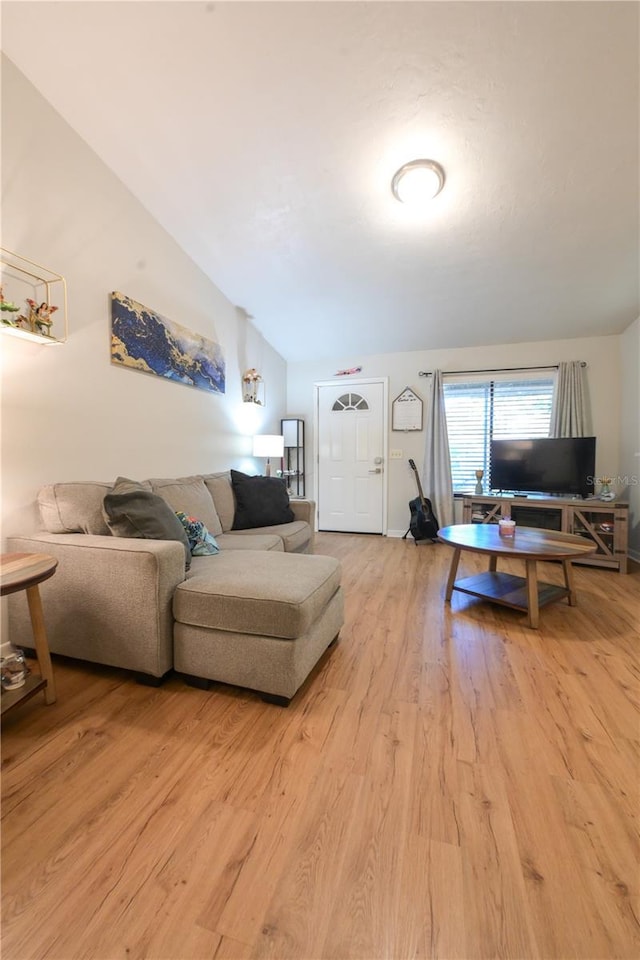 living room with vaulted ceiling and wood finished floors