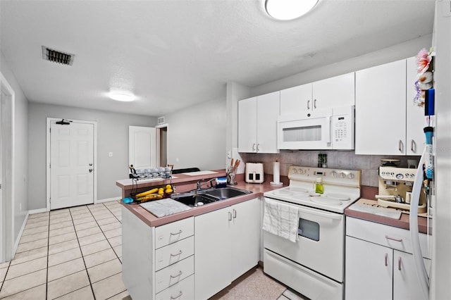 kitchen with kitchen peninsula, backsplash, white appliances, sink, and white cabinets