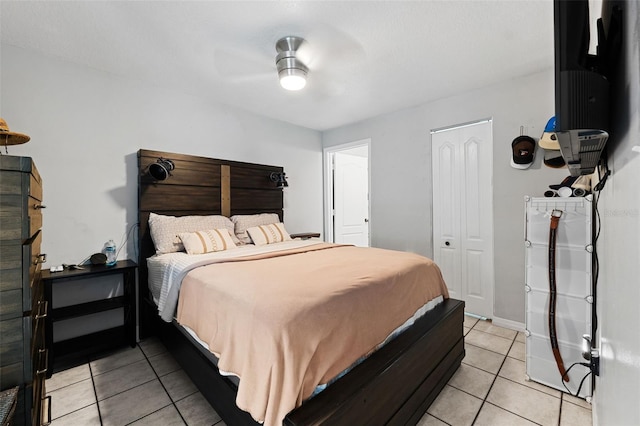 bedroom with a closet, ceiling fan, and light tile patterned flooring