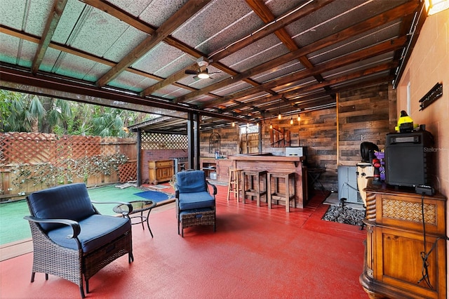 view of patio featuring ceiling fan and an outdoor bar