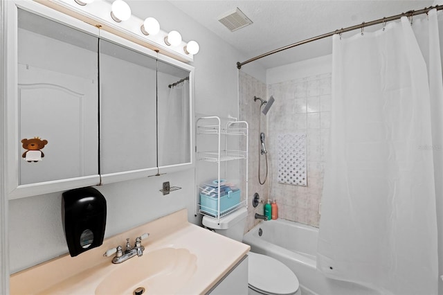 full bathroom with shower / bath combination with curtain, vanity, a textured ceiling, and toilet