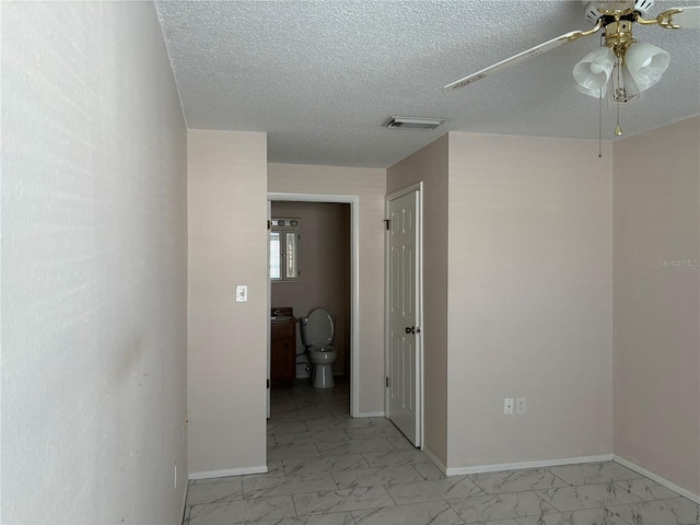 hall with a textured ceiling