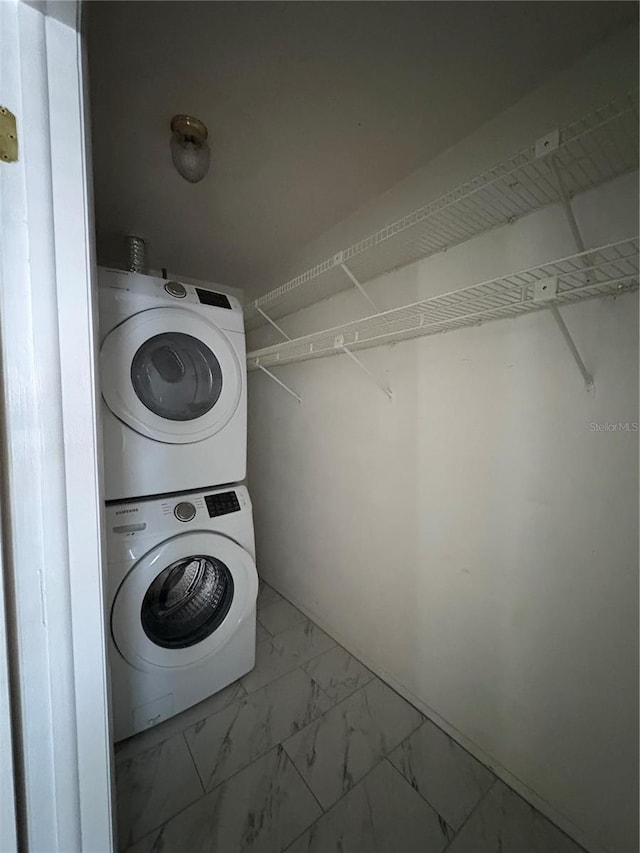 laundry area featuring stacked washer / drying machine