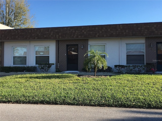 ranch-style home with a front lawn