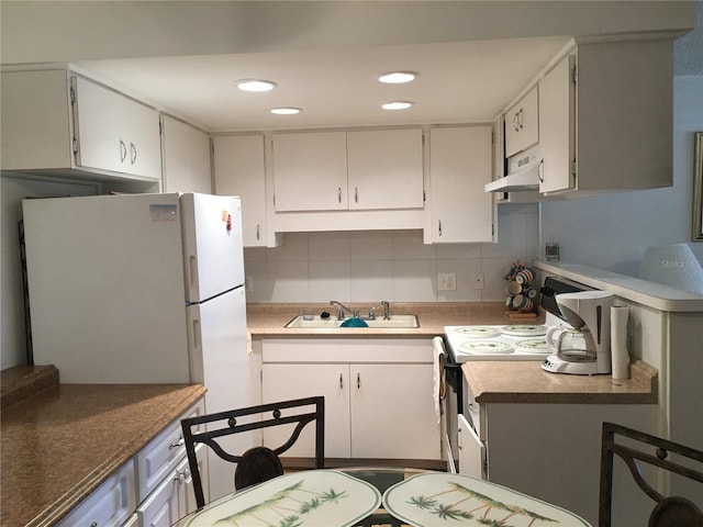 kitchen with stove, sink, decorative backsplash, range hood, and white cabinetry