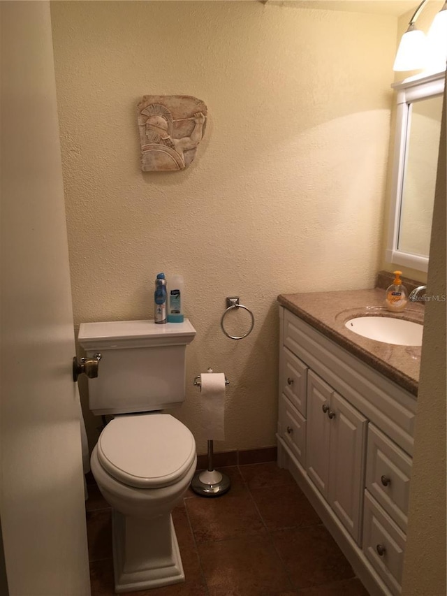 bathroom featuring tile patterned flooring, vanity, and toilet