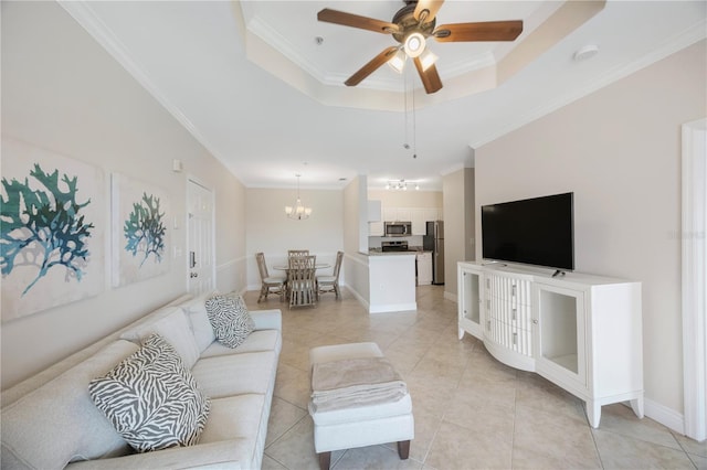 tiled living room featuring a raised ceiling, crown molding, and ceiling fan with notable chandelier