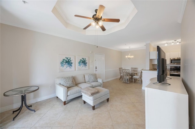 tiled living room featuring a tray ceiling and ornamental molding