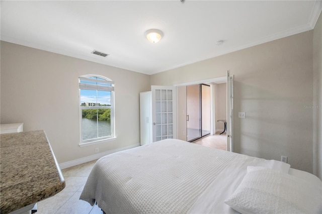 bedroom with light tile patterned floors