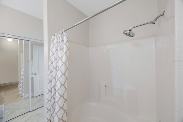 bathroom with tile patterned flooring and shower / bath combo with shower curtain