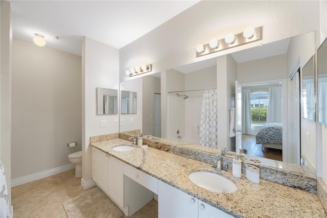 bathroom featuring tile patterned flooring, vanity, and toilet