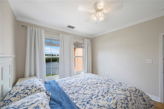 bedroom featuring wood-type flooring, ceiling fan, and crown molding