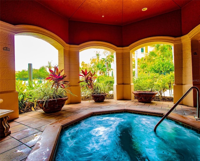 view of swimming pool with a patio area and an in ground hot tub