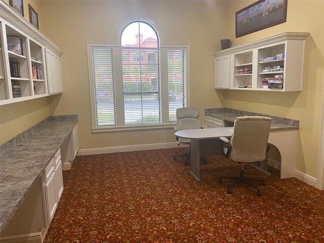 home office with a wealth of natural light and built in desk