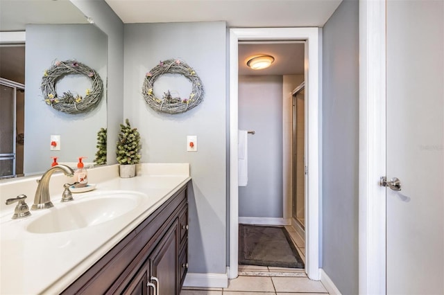 bathroom featuring tile patterned floors, vanity, and walk in shower