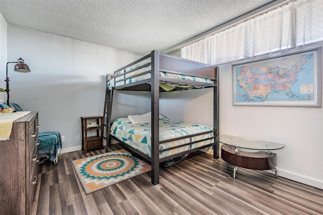 bedroom with hardwood / wood-style floors and a textured ceiling